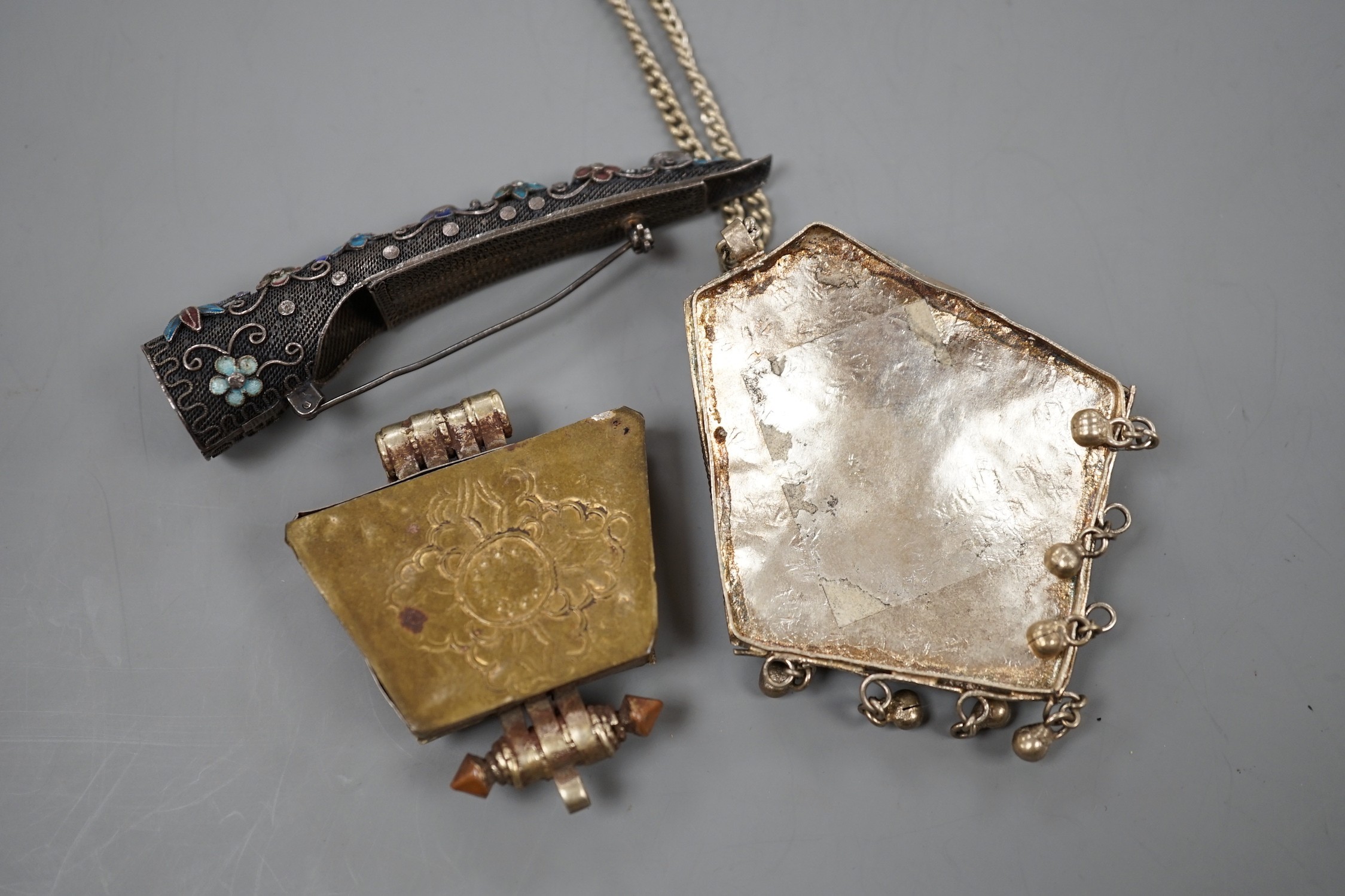 A Chinese filigree white metal, hardstone and enamel set nail guard, 86mm, together with two other Middle Eastern items.